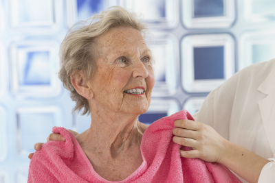 caregiver helping elder woman for shower